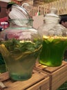 Sicilian homemade lemonade in a large jug, transparent with lemon and mint, green lemonade of kiwi and orange, sweet carbonated