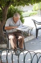 Sicilian man reading newspaper