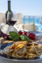 Sicilian pasta dish with traditional busiata pasta and sicilian vegetables, Viola eggplant, tomatoes served ourdoor on terrace Royalty Free Stock Photo