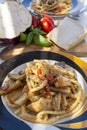 Sicilian pasta dish with traditional busiata pasta and sicilian vegetables, Viola eggplant, tomatoes served ourdoor on terrace Royalty Free Stock Photo