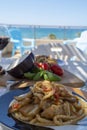 Sicilian pasta dish with traditional busiata pasta and sicilian vegetables, Viola eggplant, tomatoes served ourdoor on terrace Royalty Free Stock Photo