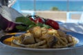 Sicilian pasta dish with traditional busiata pasta and sicilian vegetables, Viola eggplant, tomatoes served ourdoor on terrace Royalty Free Stock Photo