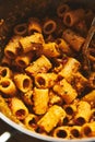 Sicilian Pesto Pasta. Pasta alla trapanese. Rigatoni pasta with pesto from cherry tomatoes and blanched almonds, basil