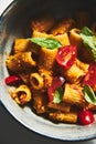 Sicilian Pesto Pasta. Pasta alla trapanese. Rigatoni pasta with pesto from cherry tomatoes and blanched almonds, basil