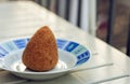 Sicilian snack, fried ball of rice arancino on a plate, tipical street food of Sicily