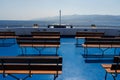 Sicily, Italy - 27.07.2024: Empty deck with benches on ferry overlooking sunny coastal landscape Royalty Free Stock Photo
