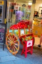 Sicily, Taormina, Italy - 28 September 2023. A brightly painted wooden cart with a basket of fresh pomegranates in front of a