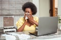 sick African American woman sneezes coughing. Freelancer, home office, work Royalty Free Stock Photo