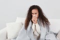 Sick African American woman with tissue at home Royalty Free Stock Photo