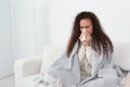 Sick African American woman with tissue at home, space for text Royalty Free Stock Photo