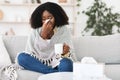 Sick afro girl wrapped in blanket drinking hot tea Royalty Free Stock Photo