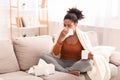 Sick Afro Woman Blowing Nose In Tissue Sitting On Sofa Royalty Free Stock Photo