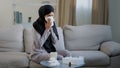 Sick arabian muslim young unhealthy woman in hijab suffer from runny nose flu disease seasonal allergy sneeze blow nose Royalty Free Stock Photo