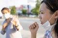 Sick asian child girl with fever and dry cough,woman opened a protective mask while coughing,spreading flu,cold,Covid-19 or Royalty Free Stock Photo