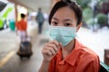 Sick asian child girl student wearing Thai school uniform with hygienic mask,health care,dust,air pollution,Pm2.5,virus protection