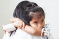 Sick asian child girl who have IV solution bandaged hugging her mother with love in hospital Royalty Free Stock Photo