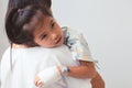 Sick asian child girl who have IV solution bandaged hugging her mother in the hospital Royalty Free Stock Photo