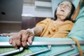 Sick Southeast Asian female senior patient with respiratory disorder having bedrest in hospital Royalty Free Stock Photo