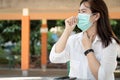 Sick asian female people with cold,flu,woman wearing hygienic mask and touch the neck with fever,cough,sore throat or Corona virus Royalty Free Stock Photo