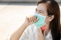 Sick asian female people with tonsillitis angina,woman wearing mask,touch the neck with cough,sore throat pain irritation,hard to Royalty Free Stock Photo