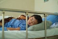 Sick Asian kid boy 2 years old lying sick in hospital bed. Royalty Free Stock Photo