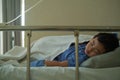 Sick Asian kid boy 2 years old lying sick in hospital bed. Royalty Free Stock Photo