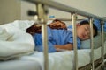 Sick Asian kid boy 2 years old lying sick in hospital bed. Royalty Free Stock Photo