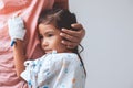 Sick asian little child girl hugging her mother Royalty Free Stock Photo