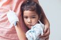 Sick asian little child girl hugging her mother Royalty Free Stock Photo