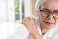 Sick asian old senior woman with a shoulder bone pain,dislocated shoulder joint,painful due to dislocation of the shoulder,chronic Royalty Free Stock Photo