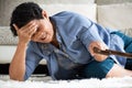 Sick asian old woman with headache lying on the floor after falling down at home. Senior healthcare concept Royalty Free Stock Photo