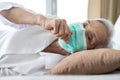 Sick asian senior woman in bed,wear face protection mask,fever and coughing,pneumonia disease,elderly patient has ill,flu and cold Royalty Free Stock Photo
