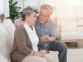 Sick asian senior woman or grandmother is fainted and fallen on floor, grandfather help,care,support of her,elderly people Royalty Free Stock Photo