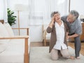 Sick asian senior woman or grandmother is fainted and fallen on floor, grandfather help,care,support of her,elderly people Royalty Free Stock Photo