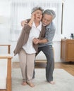 Sick asian senior woman or grandmother is fainted and fallen on floor, grandfather help,care,support of her,elderly people Royalty Free Stock Photo