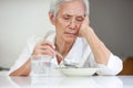 Sick asian senior woman suffering from anorexia,bored with meal,eating less food,discomfort in swallowing,disease of Dysphagia,Old Royalty Free Stock Photo