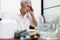 Sick asian senior woman touch her head with hand suffering from dizziness,headache,painful in the head,physical health problem,old Royalty Free Stock Photo