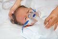 Sick baby boy applying inhale medication by inhalation mask to cure Respiratory Syncytial Virus RSV on patient bed at hospital