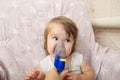 Sick baby girl use nebulizer mask for inhalation, respiratory procedure by pneumonia or cough for child