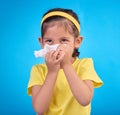 Sick, blowing nose and napkin with girl in studio for allergies, illness and sneezing. Hay fever, bacteria and sinus Royalty Free Stock Photo