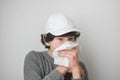 A boy coughing into a Kleenex Tissue Royalty Free Stock Photo