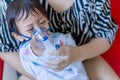 Sick boy inhalation therapy by the mask of inhaler. Baby has asthma and need nebulizations. Patient Boy use inhalation with Nebuli Royalty Free Stock Photo