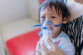 Sick boy inhalation therapy by the mask of inhaler. Baby has asthma and need nebulizations Royalty Free Stock Photo