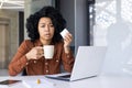 Sick business woman with cold and runny nose drinking hot beverage while working from home Royalty Free Stock Photo