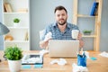 Sick businessman with grippe sitting in office and holding a cup of tea Royalty Free Stock Photo