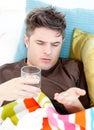 Sick caucasian man taking pills with water Royalty Free Stock Photo