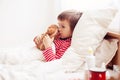 Sick child boy lying in bed with a fever, resting Royalty Free Stock Photo