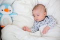 Sick child boy lying in bed with a fever, resting at home Royalty Free Stock Photo