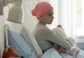 Sick child with cancer sitting in hospital bed Royalty Free Stock Photo