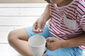 Sick child eating pills with wooden white background .Top view Royalty Free Stock Photo